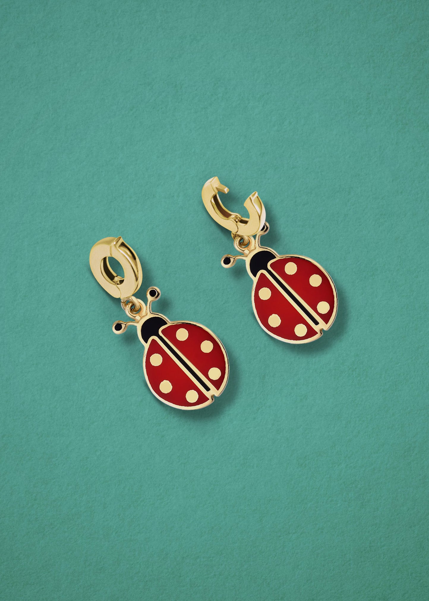 Lucky Ladybird Charm showing both open and closed views of the 14K solid gold clip, with red and black enamel, displayed on a purple background.