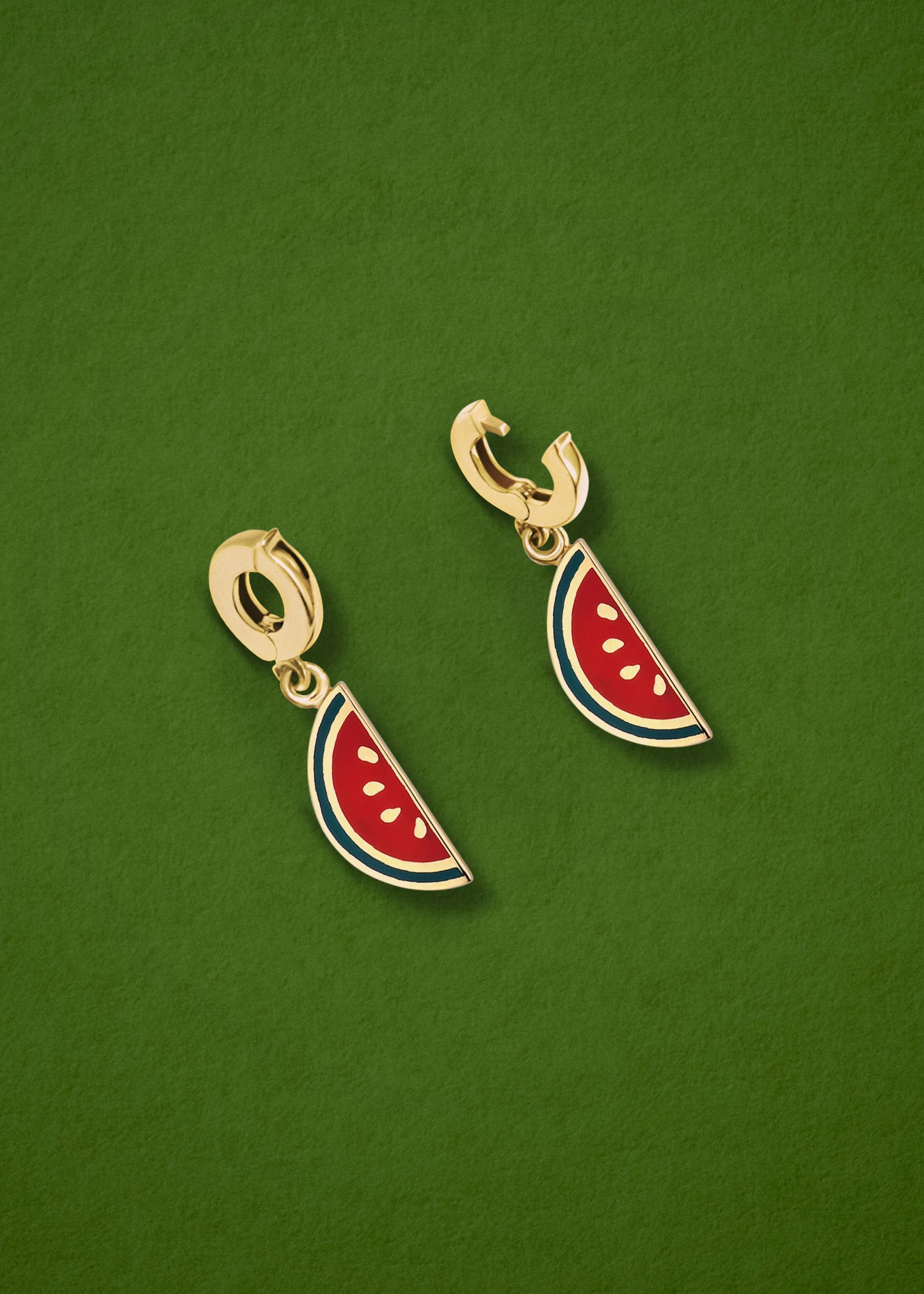 Watermelon Wonder Charm showing both open and closed views of the 14K solid gold clip, with pink and green enamel, displayed on a green background.